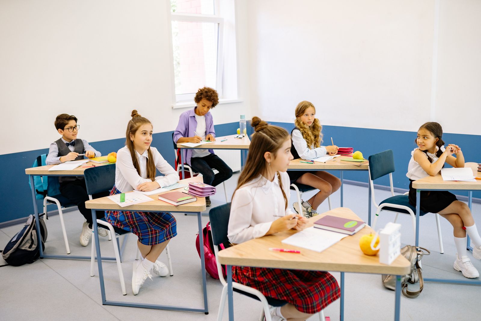Pupils learning together in a bright classroom